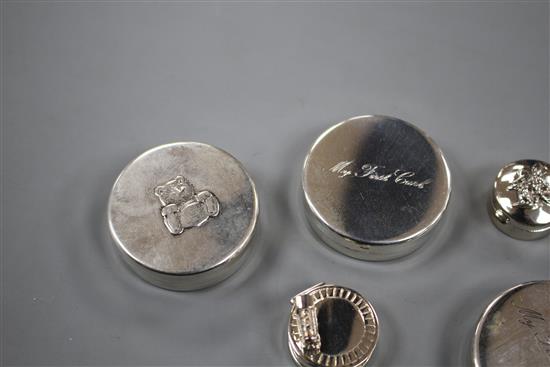 Six modern silver tooth fairy circular boxes, including two My First Curl boxes and one surmounted with a steam engine,